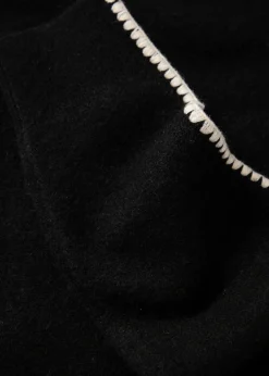 Stickad tröja med dekorativa sömmar